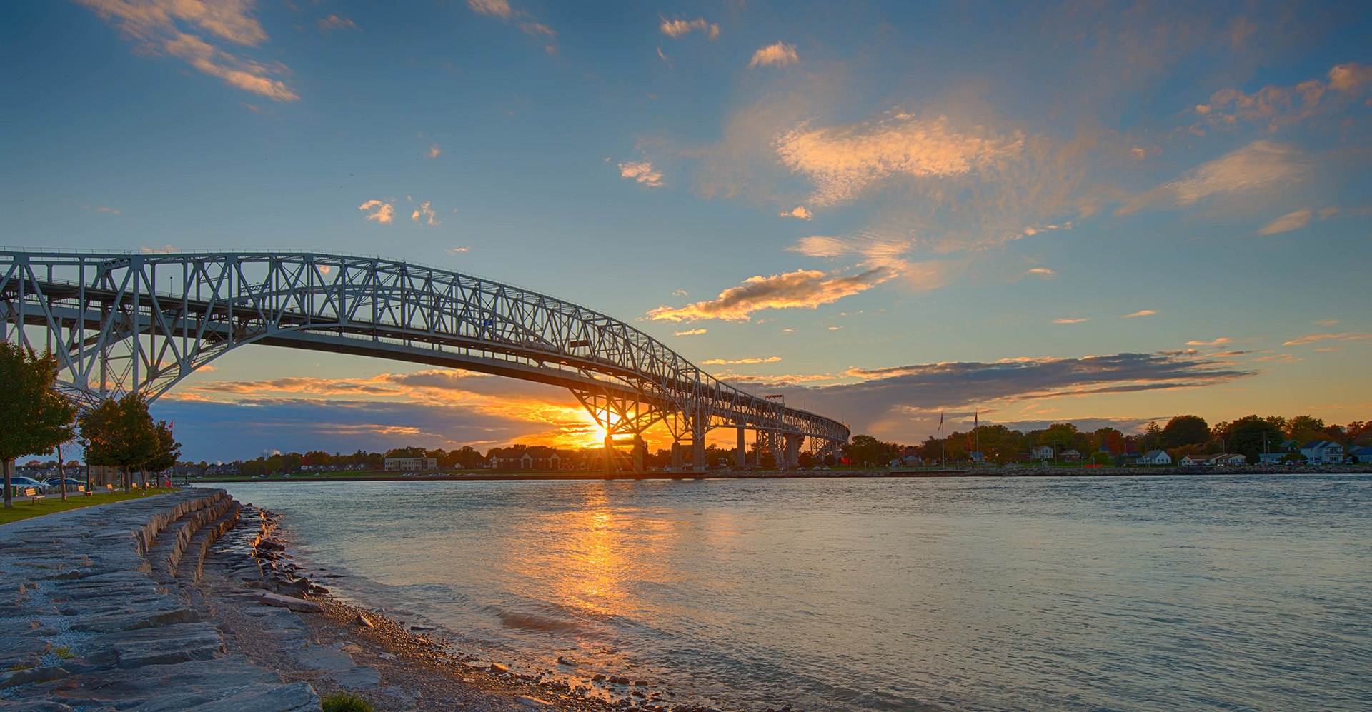 a shoreline photo of the blue water bridge at sunset